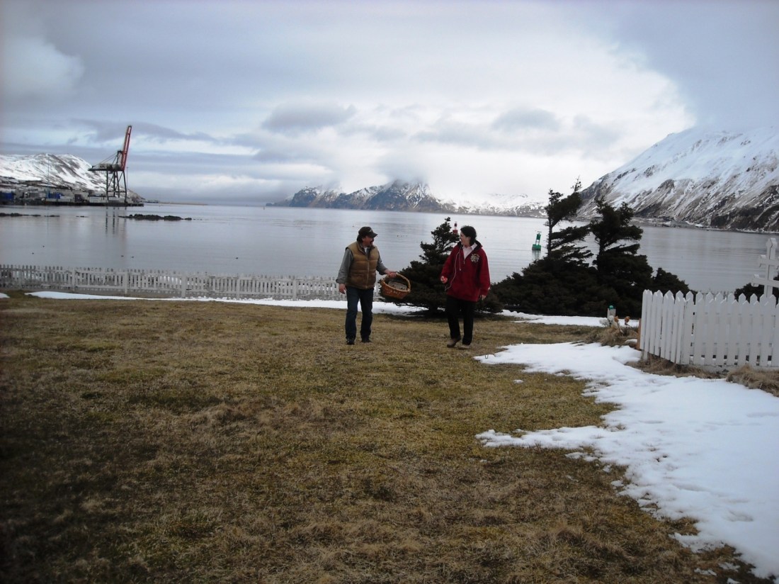 Caleb finishes hiding eggs in the churchyard.