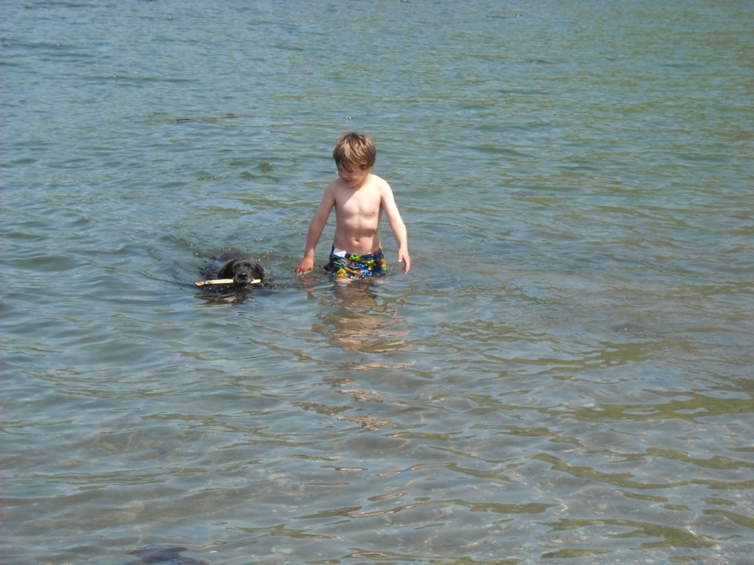 Teva, with her stick and her best friend.  In the Bay.